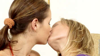 Two lesbian women caress and kiss for our pleasure