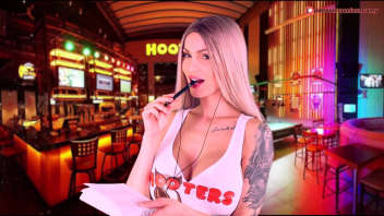 A Hooters hostess just for us: A blonde with generous assets