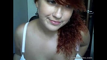 Busty redhead does a tease on cam