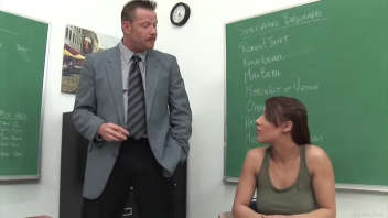Magnifying brunette gets kissed in the classroom